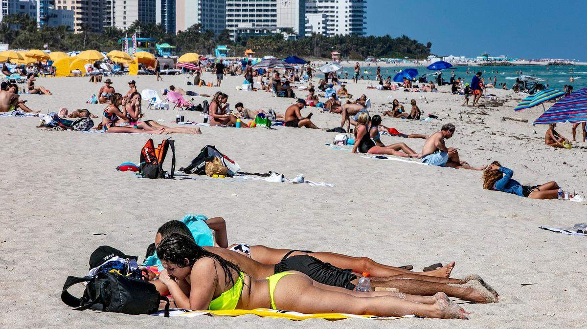 Sunbathers enjoy the weather March 2, 2021 in Miami Beach.