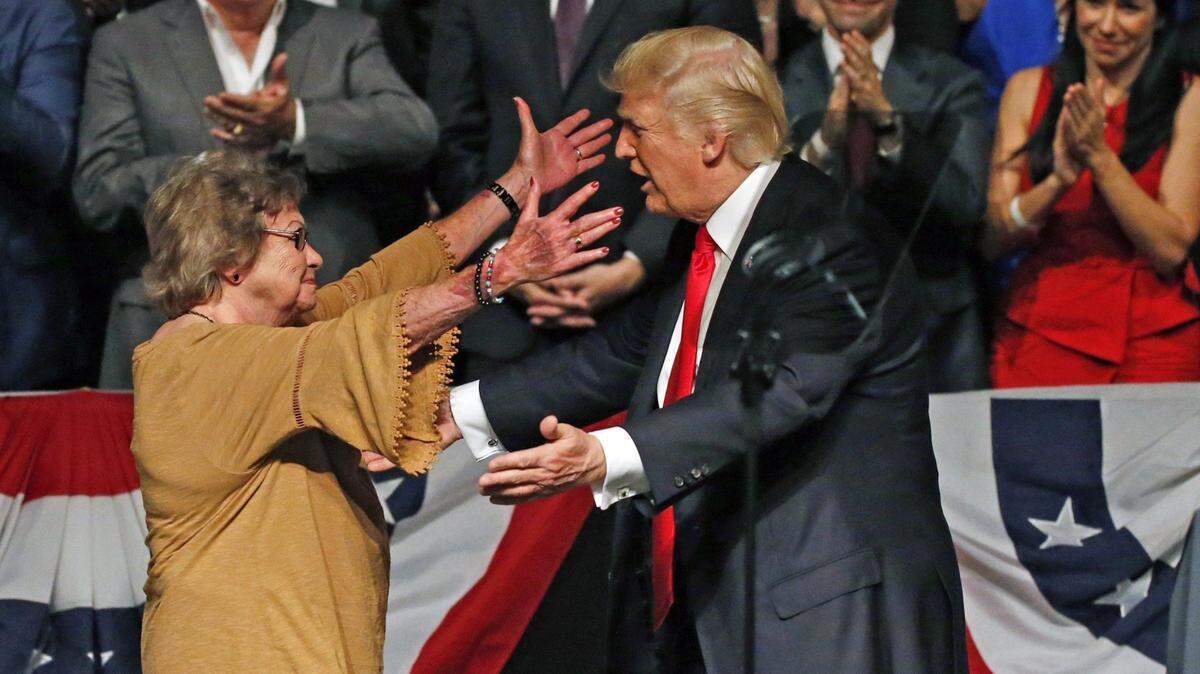 Then-President Trump greets Cuban dissident Cary Roque before announcing his Cuba policy at the Manuel Artime Theater in Miami in 2017.