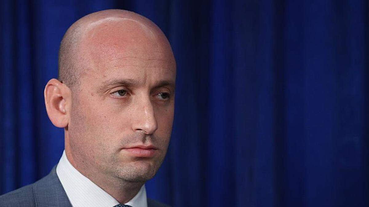 PALM BEACH, FLORIDA - JANUARY 03: White House Deputy Chief of Staff and Homeland Security Advisor Stephen Miller listens as U.S. President Donald Trump addresses the media during a news conference at his Mar-a-Lago club on January 03, 2026, in Palm Beach, Florida. President Trump confirmed that the U.S. military carried out a large-scale strike in Caracas overnight, resulting in the capture of Venezuelan leader Nicolas Maduro and his wife, Cilia Flores. (Photo by Joe Raedle/Getty Images)