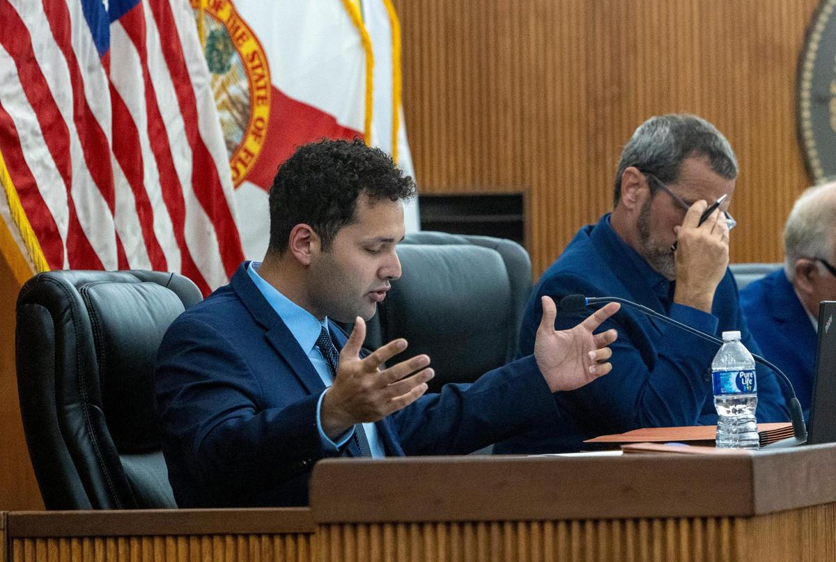 Councilman Bryan Calvo, left, explains why he sued Mayor Esteban Bovo Jr., alleging “abuse of power.”