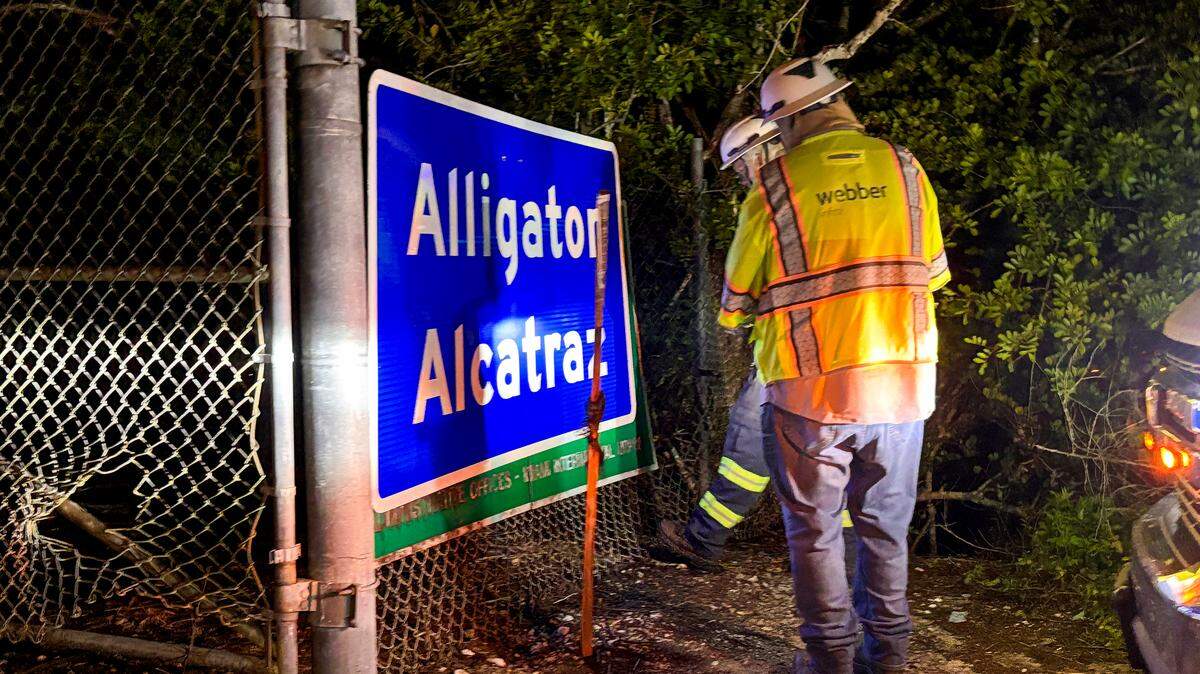 Dos trabajadores instalan el cartel en la entrada al centro de detención de inmigrantes de “Alligator Alcatraz” el 2 de julio de 2025.