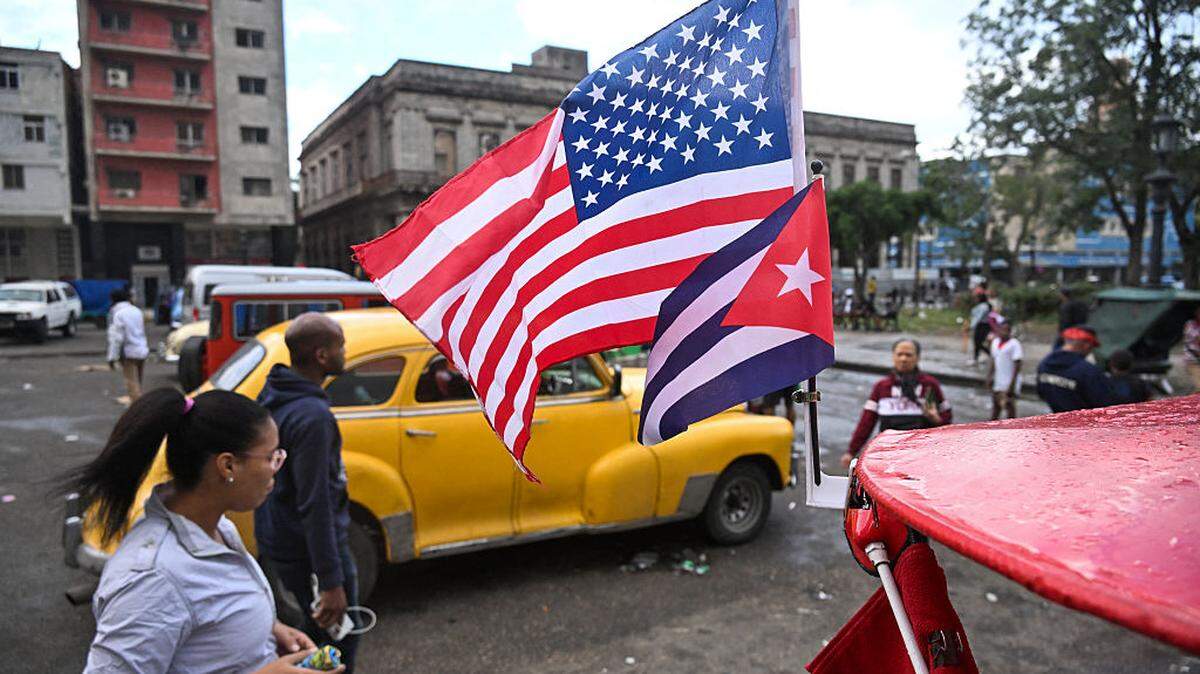 A Cuban and a US flag flutter on the roof of a tricycle in Havana on January 30, 2026. Cuban President Miguel Diaz-Canel on January 30, 2026, denounced US President Donald Trump's attempt to "asphyxiate" the communist island's economy under a "false pretext." (Photo by YAMIL LAGE / AFP via Getty Images)