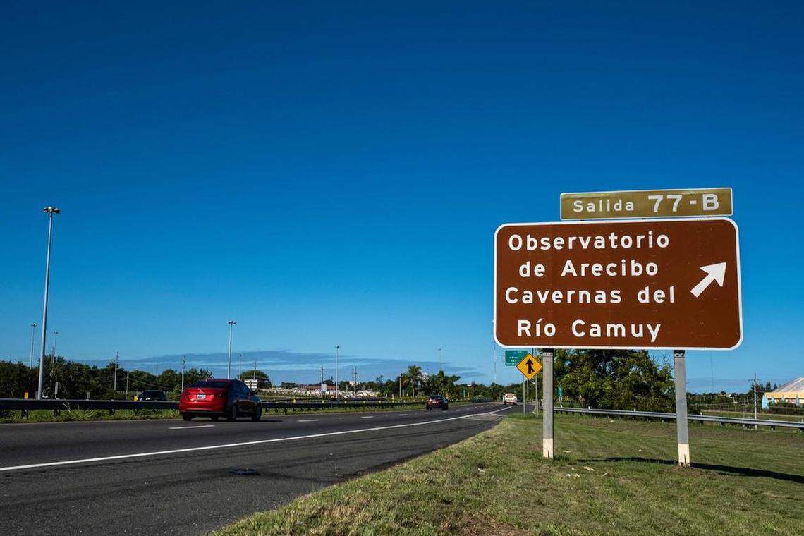 A road sign on the highway in Arecibo points the way to the Arecibo Observatory.