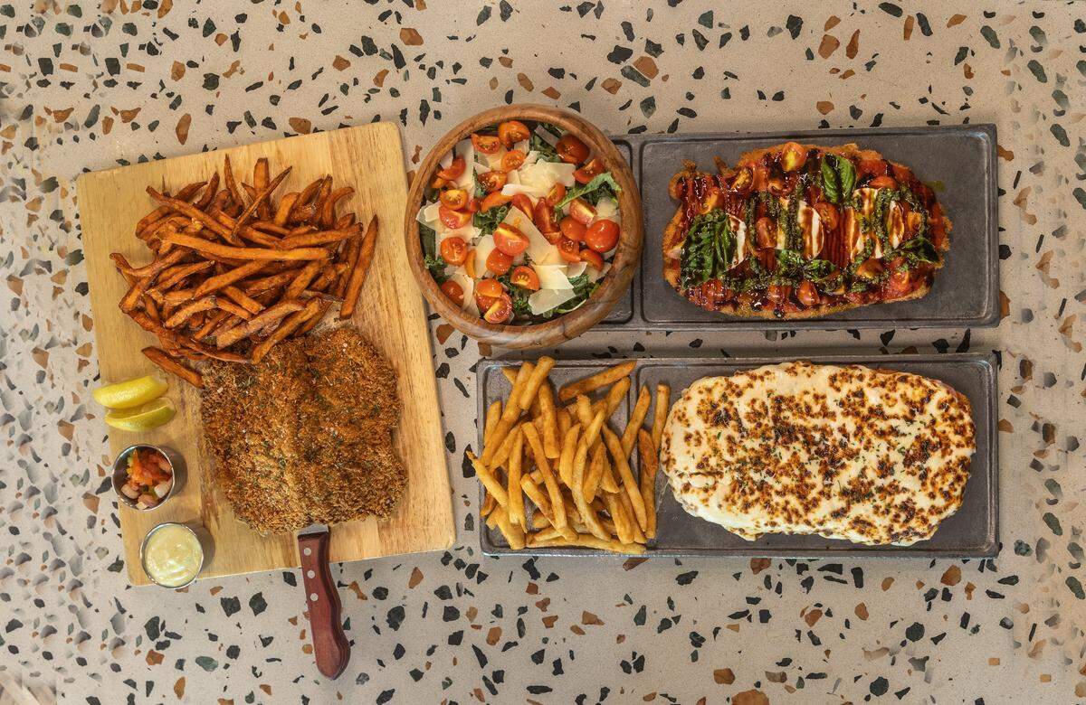 From left clockwise- A New York Strip Milanesa, Chicken Milanesa Margherita and a Milanesa Napolitana, from the menu at La Casa de La Milanesa located in the Midtown area in Miami, on Tuesday, May 26, 2026.