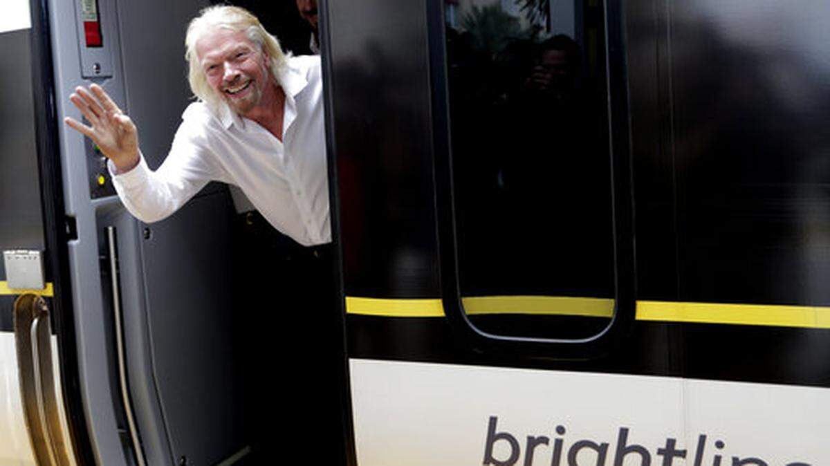 Virgin founder Richard Branson salutes passengers April 4, 2019.
