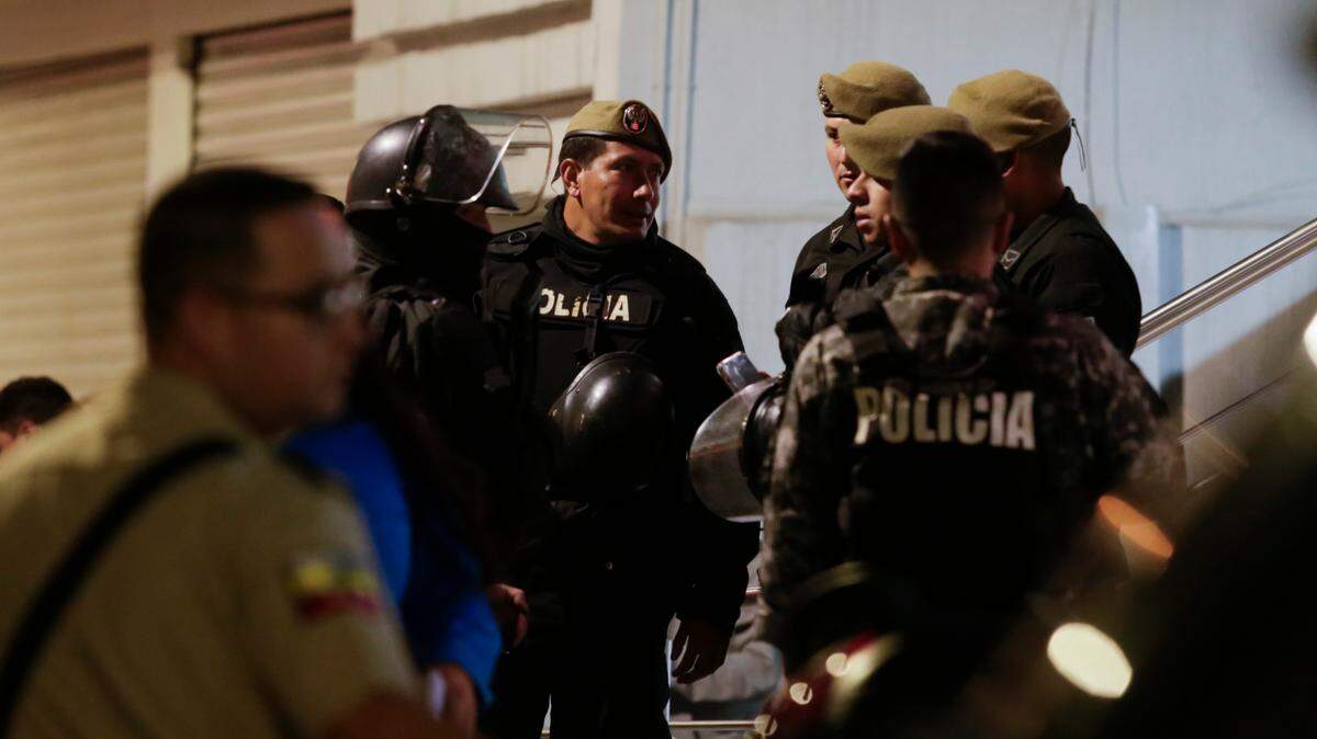 Police guard the hospital where several of the injured were taken after the Aug. 9 attack that killed presidential candidate Fernando Villavicencio in Quito, Ecuador.