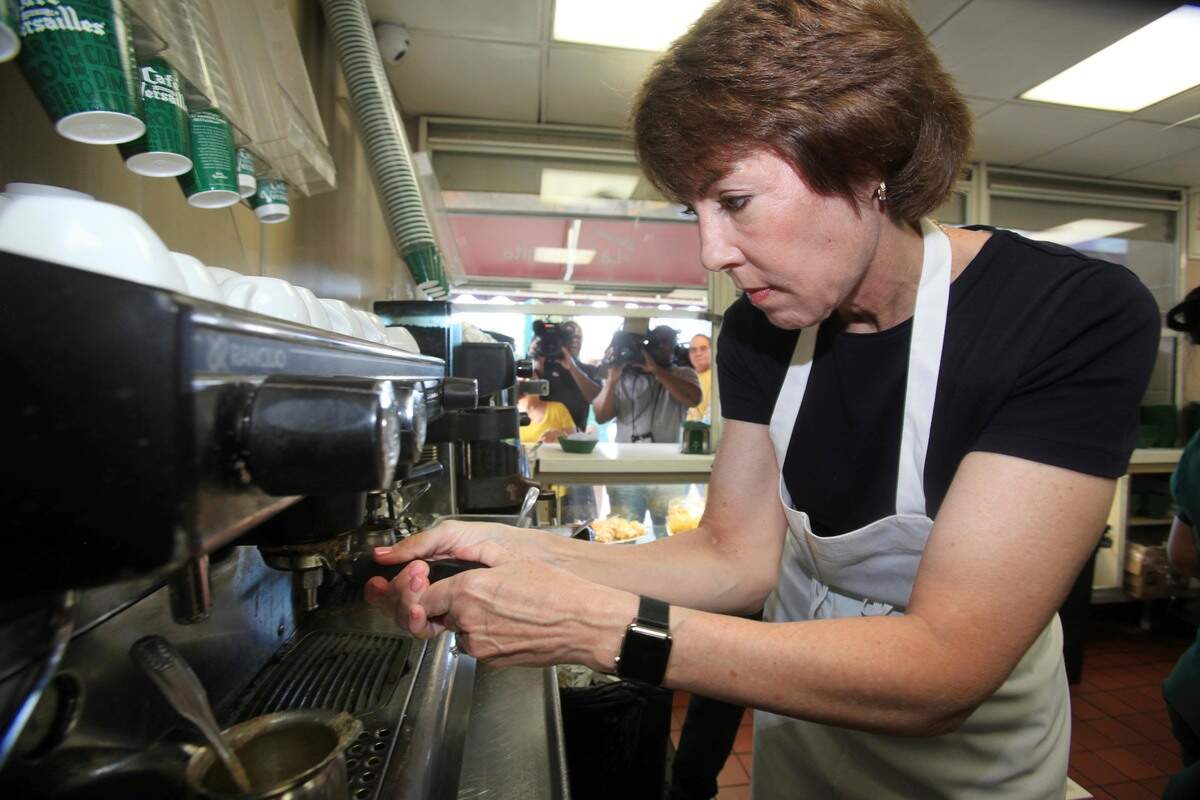 La candidata Gwen Graham aprende a hacer café cubano durante una visita al restaurante Versailles el 28 de agosto del 2018.