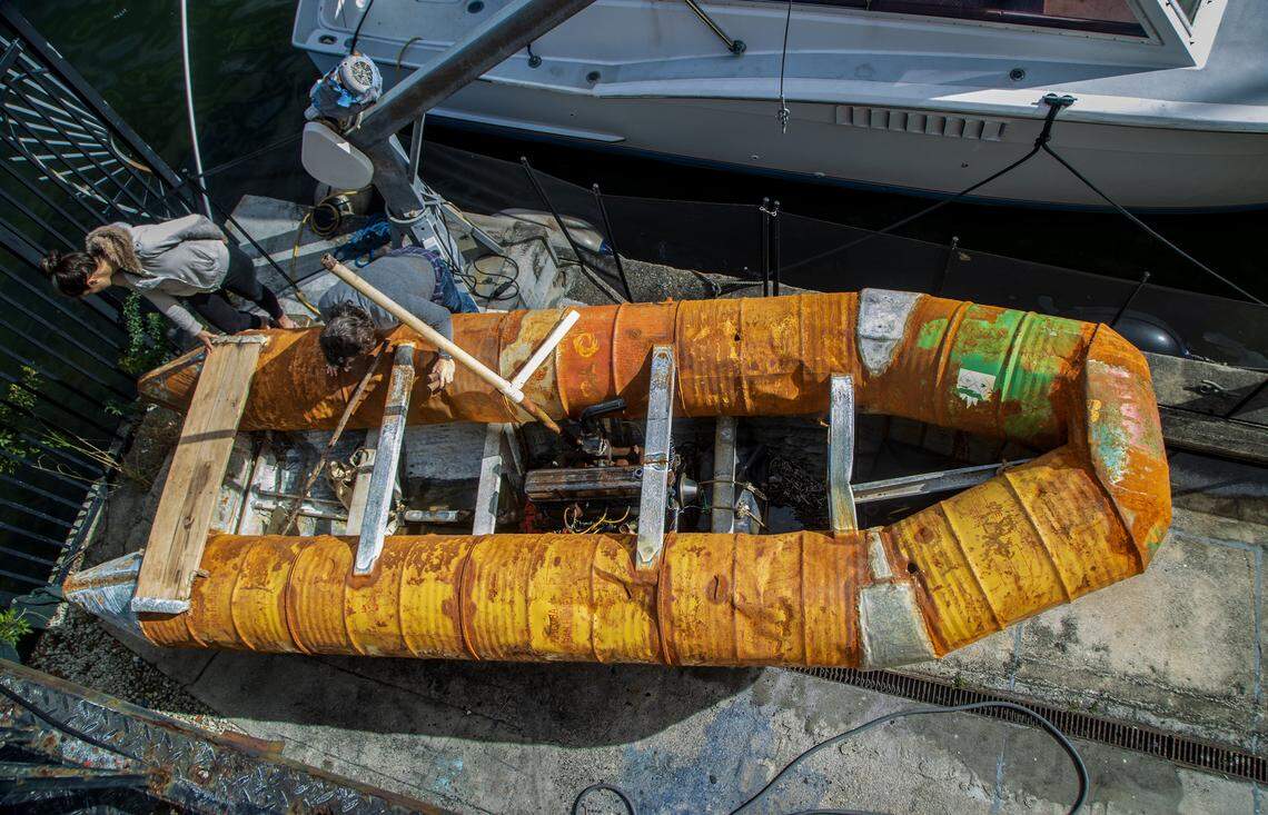 Cuban American artists Antonia Wright and artist Ruben Millares check a raft recovered from the coast of Miami The raft, built with metal barrels, has a truck engine from a 1942 Chevrolet, and now is part of their new show titled “Exile” at the Piero Atchugarry Gallery, on view until May 2