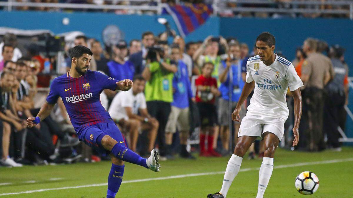 Barcelona forward Luis Suarez pass the ball against Real Madrid defender Raphael Varane during the first half of  ‘’El Clasico Miami’’ Barcelona-Real Madrid match as part of the International Champions Cup on Saturday, July 29, 2017, at Hard Rock Stadium in Miami Gardens.