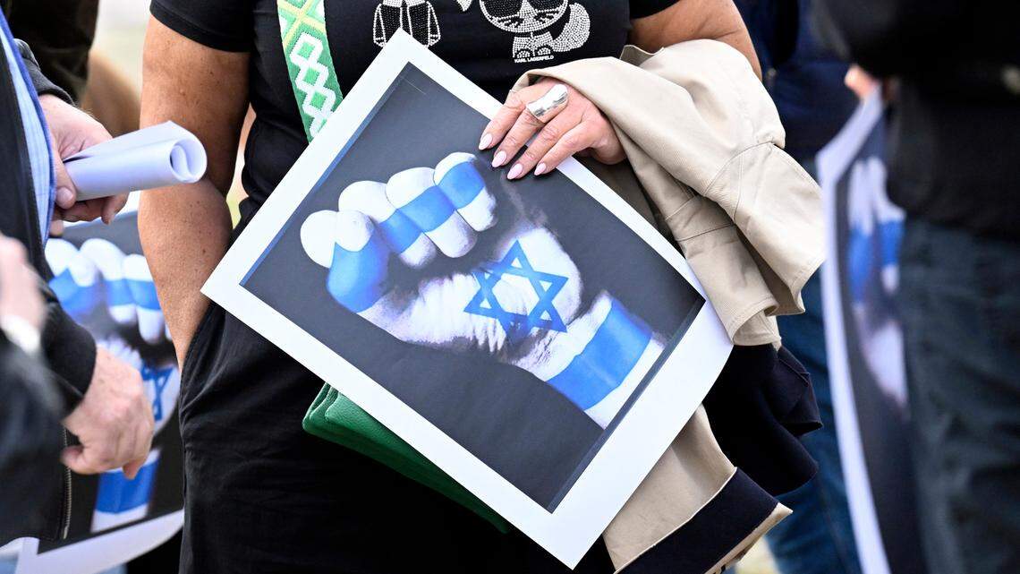A woman holds a poster expressing solidarity with Israelis during an Oct. 8 protest in Düsseldorf, Germany, against the Hamas. attacks.