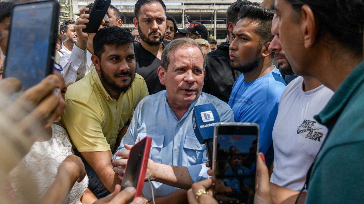 Venezuelan political leader Juan Pablo Guanipa speaks with a journalist as he is surrounded by supporters outside the Basilica of the Virgin of La Chinita in Maracaibo, Zulia state, Venezuela, on February 20, 2026. Venezuelan opposition leader Juan Pablo Guanipa, an ally of Nobel Peace Prize laureate MarÃa Corina Machado, announced in the early hours of Friday that he had been granted "full freedom" just hours after the approval of a historic amnesty law in Parliament. (Photo by John ChacÃ³n / AFP via Getty Images)