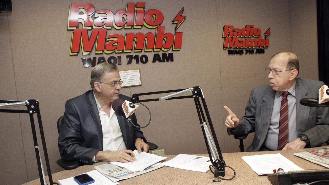 Radio personalities Oscar Haza, left, and Armando Perez Roura discuss the days events on a Radio Mambi radio show on July 4, 2012, at Univision Radio Studios in Miami, along with Ninoska Perez Castell.