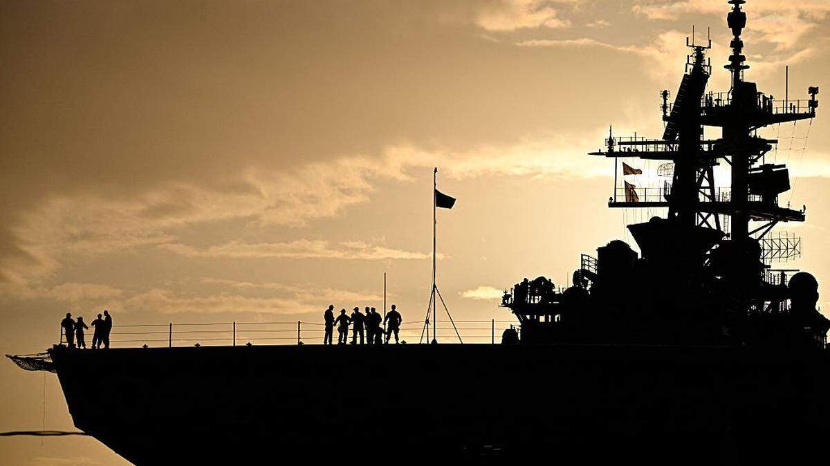 TOPSHOT - The Wasp-class amphibious assault ship USS Iwo Jima (LHD7) is docked at Rafael Cordero Santiago Port of the America on December 16, 2025 in Ponce, Puerto Rico. President Donald Trump administration is conducting a military campaign in the Caribbean and eastern Pacific, deploying naval and air forces for what it calls an anti-drugs offensive. (Photo by Miguel J. Rodriguez Carrillo / AFP via Getty Images)