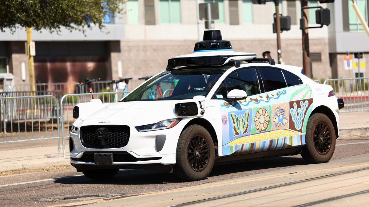 A Waymo autonomous self-driving Jaguar electric vehicle is seen in Tempe, Arizona, on the outskirts of Phoenix, on September 15, 2025. (Photo by CHARLY TRIBALLEAU / AFP) (Photo by CHARLY TRIBALLEAU/AFP via Getty Images)