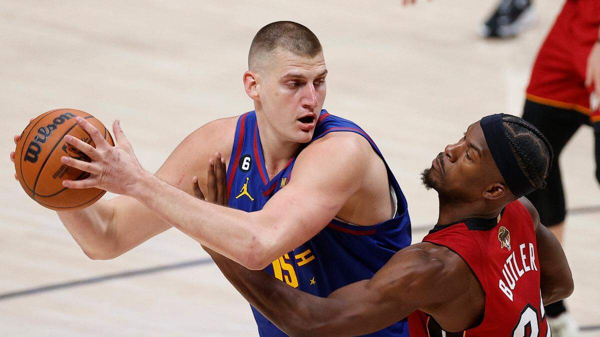 El centro de los Nuggets Nikola Jokic (izq.) trata de pasar la marca de Jimmy Butler, del Heat de Miami, en el partido celebrado el 1ro de junio de 2023 en Denver.