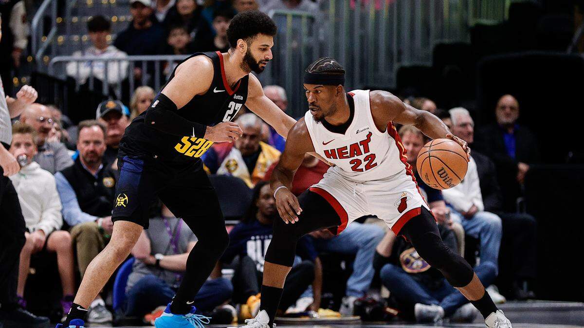 Feb 29, 2024; Denver, Colorado, USA; Miami Heat forward Jimmy Butler (22) controls the ball as Denver Nuggets guard Jamal Murray (27) guards in the first quarter at Ball Arena. Mandatory Credit: Isaiah J. Downing-USA TODAY Sports