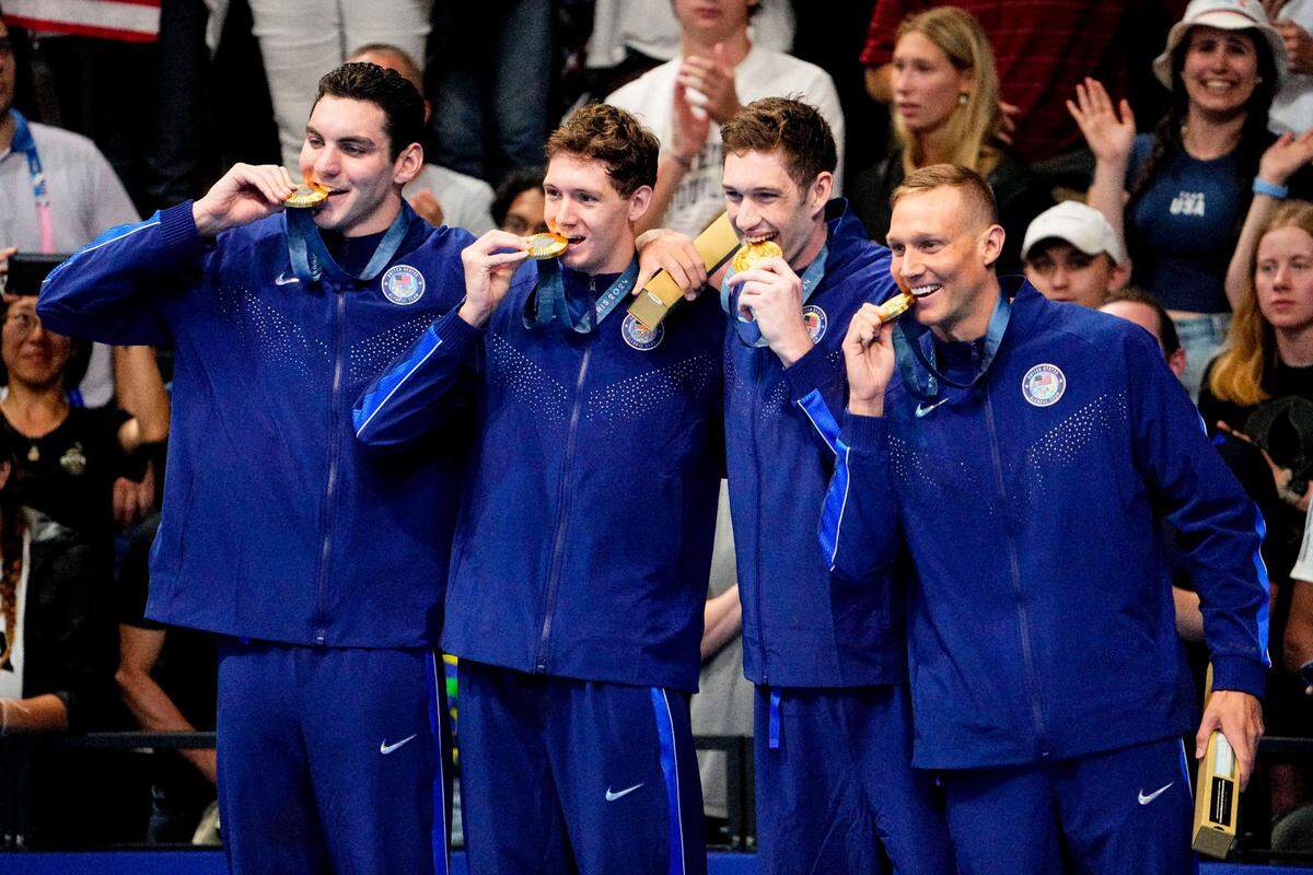 U.S. swimmers Jack Alexy, Chris Guiliano, Hunter Armstrong and Caeleb Dressel celebrate their gold-medal winning performance in the 4 x 100 free relay on Saturday at the Paris Olympics.