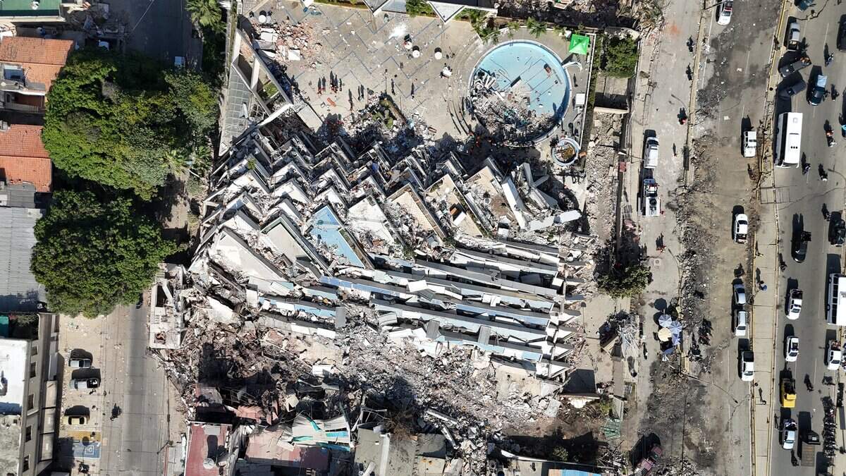 This aerial view shows a collapsed multi-storey building and surrounding debris near a coastal road following the June 24 twin earthquakes in Caraballeda, La Guaira State, Venezuela, on June 29, 2026. Hopes were fading of finding survivors more than four days after powerful twin earthquakes struck Venezuela, as residents grow increasingly frustrated with the government's response to the disaster that has killed -up to now- more than 1,700 people and left tens of thousands unaccounted for. (Photo by Yorman MALDONADO / AFP via Getty Images)