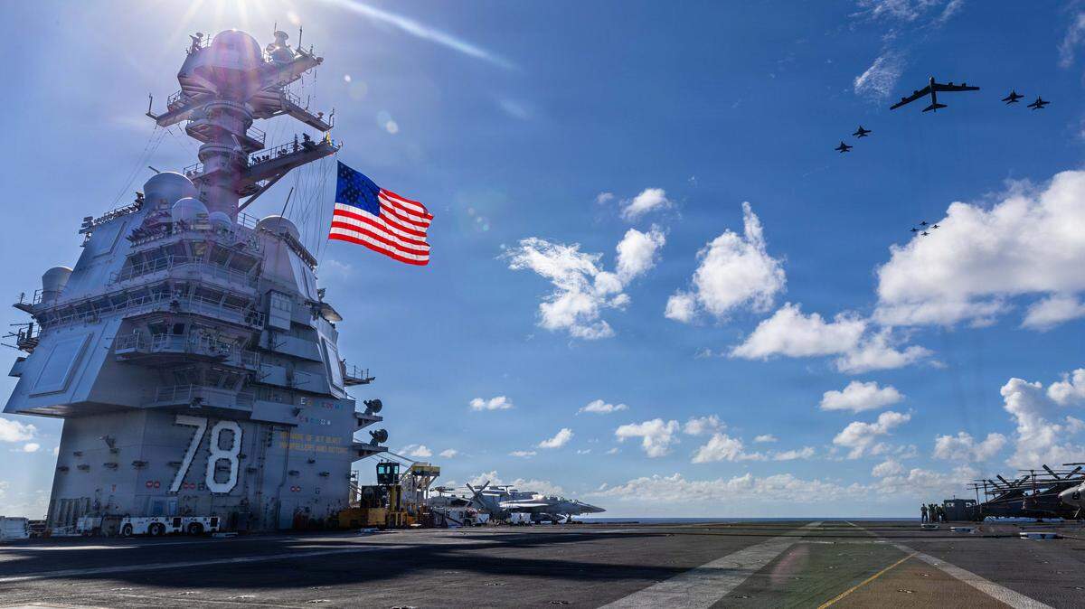 AT SEA- NOVEMBER 13: In this handout provided by the U.S. Navy, USS Gerald R. Ford (CVN 78), F/A-18E/F Super Hornets assigned to Strike Fighter Squadrons 31, 37, 87, and 213 from embarked Carrier Air Wing Eight, and a U.S. Air Force B-52 Stratofortress operate as a joint, multi-domain force, November 13, 2025. U.S. military forces, like the Gerald R. Ford Carrier Strike Group, are deployed in support of the U.S. Southern Command mission, Department of War-directed operations, and the President's priorities to disrupt illicit drug trafficking and protect the homeland. (Photo by Paige Brown/US Navy via Getty Images)