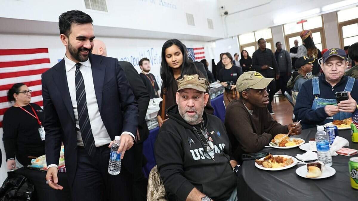 NEW YORK, NEW YORK - NOVEMBER 11: New York Mayor-Elect Zohran Mamdani speaks with veterans during a Veteran's Day event at Volunteers of America - Commonwealth Veterans' Residence on November 11, 2025 in the Soundview neighborhood of the Bronx borough in New York City. Mamdani observed Veteran's day by serving meals, speaking with and listening to the concerns of veterans and speaking about the work his upcoming administration will be doing to help. (Photo by Michael M. Santiago/Getty Images)