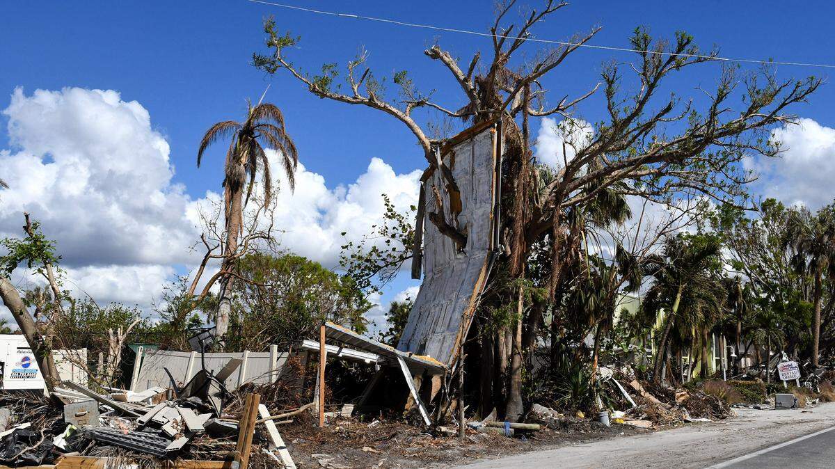 Debris from a home came to rest in a tree along a road on Sanibel Island, Florida, a month after Hurricane Ian made landfall as a Category 4 hurricane.