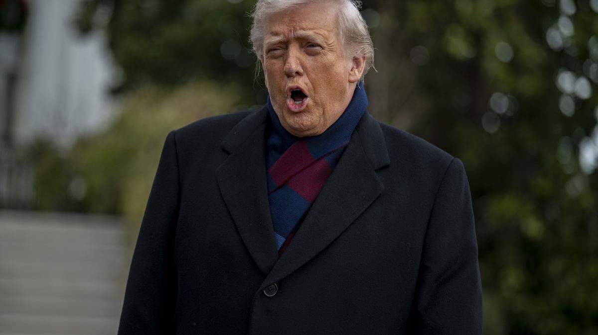 US President Donald Trump talks to members of the press before boarding Marine One from the South Lawn of the White House in Washington, DC, on December 13, 2025. President Trump is on his way to attend the Army vs. Navy college football game in Baltimore. (Photo by DANIEL HEUER / AFP via Getty Images)