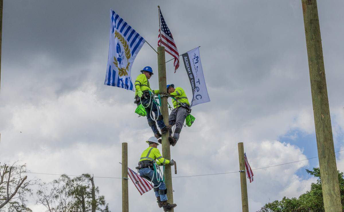 Graduates of the Telecommunications and Fiber Optics Technician program at Miami Dade College’s North Campus demonstrate what they have learned during a graduation presentation. The program is part of a collaboration between Miami Dade College and MasTec, on Thursday, Feb. 27, 2025.