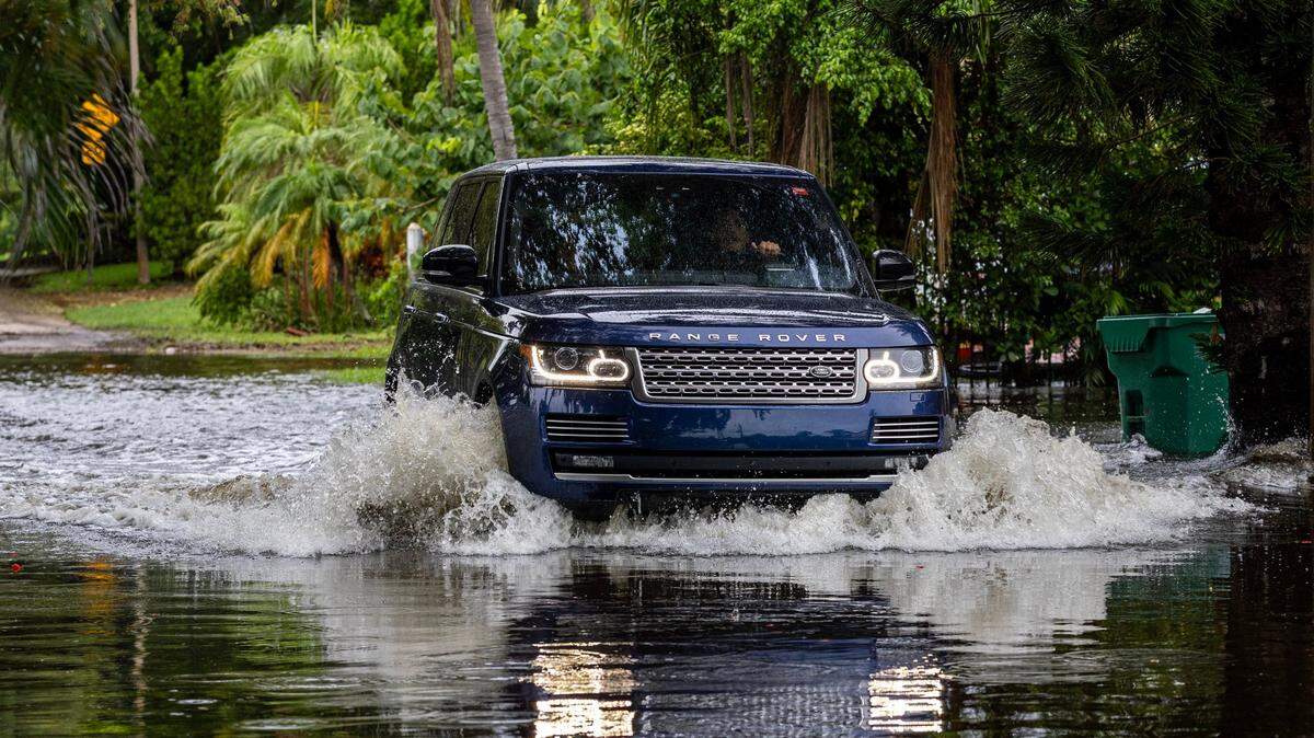 The flooded condition of a Miami Shores street after a June 2024 downpour is a small part of a broader problem in Miami-Dade County. New legislation aims to reduce neighborhood flooding by requiring new driveways, patios and pool decks to drain more easily than they do now.