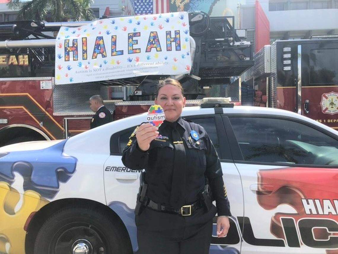 Former Sergeant Salgado now Lieutenant holds the sticker promoted by the city to recognize that a person with autism lives in a home in Hialeah