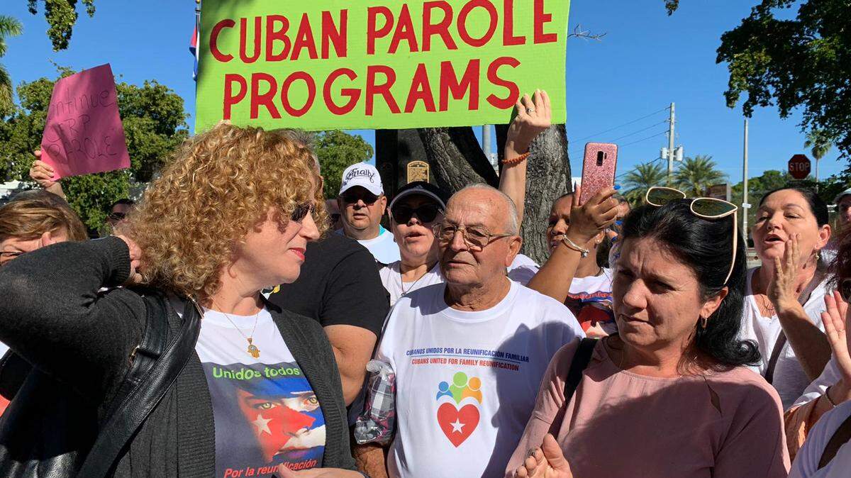 A group of protesters hold signs and scream in favor of the reinstatement of the Cuban Family Reunification Parole Program. The protest took place Sunday, Dec. 15, 2019 at the Cuban Memorial Park in Miami.