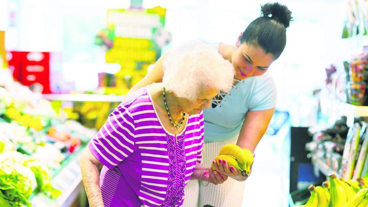 Una cuidadora ayuda a una anciana. Foto de archivo.