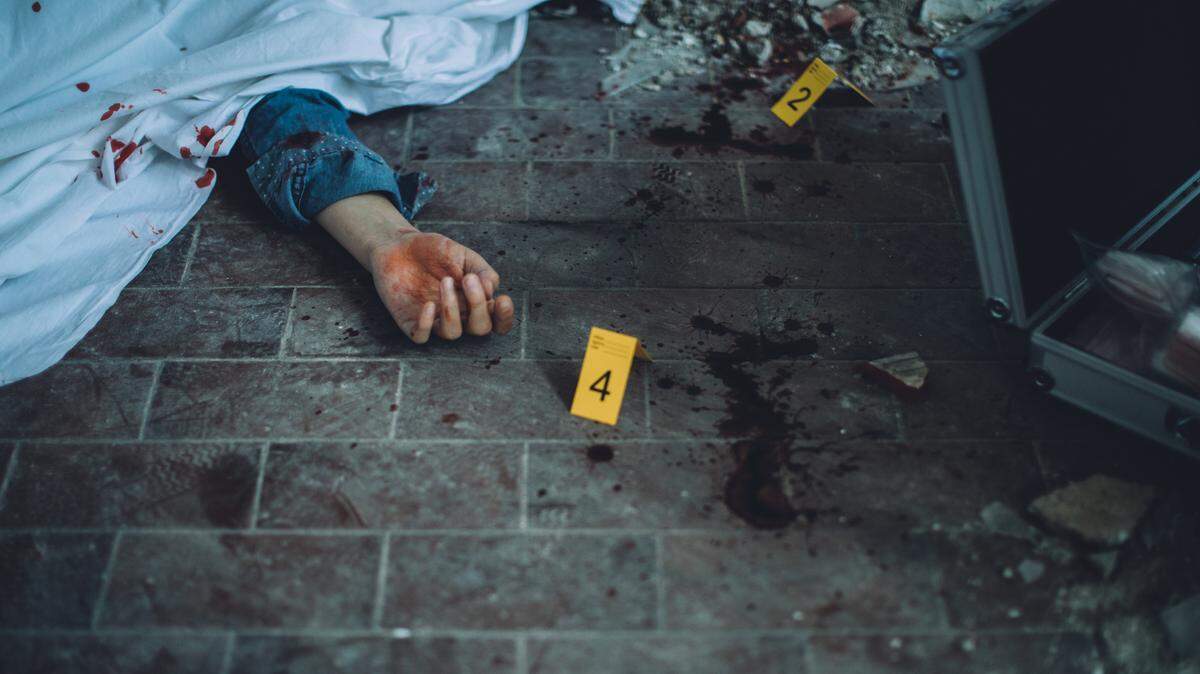 Detectives and forensics on murder crime scene collecting evidence