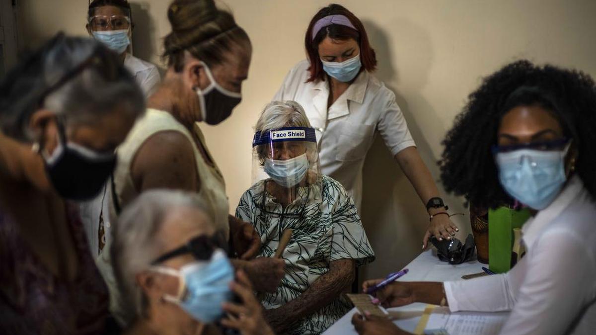 People sign up to get a COVID-19 shot in Havana in June as the government ramps up vaccination with its homegrown Abdala and Soberana vaccines.