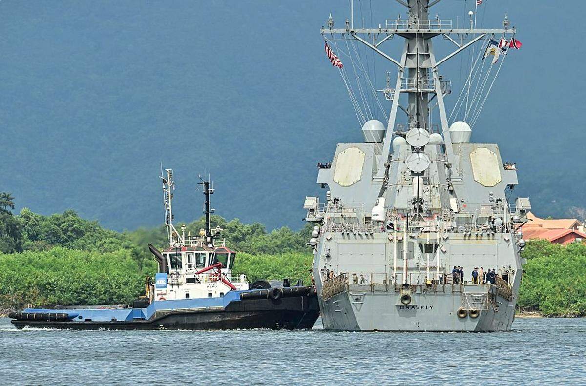 A tug boat assist the USS Gravely warship to dock at Port of Spain on October 26, 2025. Trinidad and Tobago Prime Minister Kamla Persad-Bissessar on Monday rejected a threat by neighboring Venezuela to pull the plug on a joint gas project over her government's hosting of an American warship. (Photo by MARTIN BERNETTI / AFP) (Photo by MARTIN BERNETTI/AFP via Getty Images)