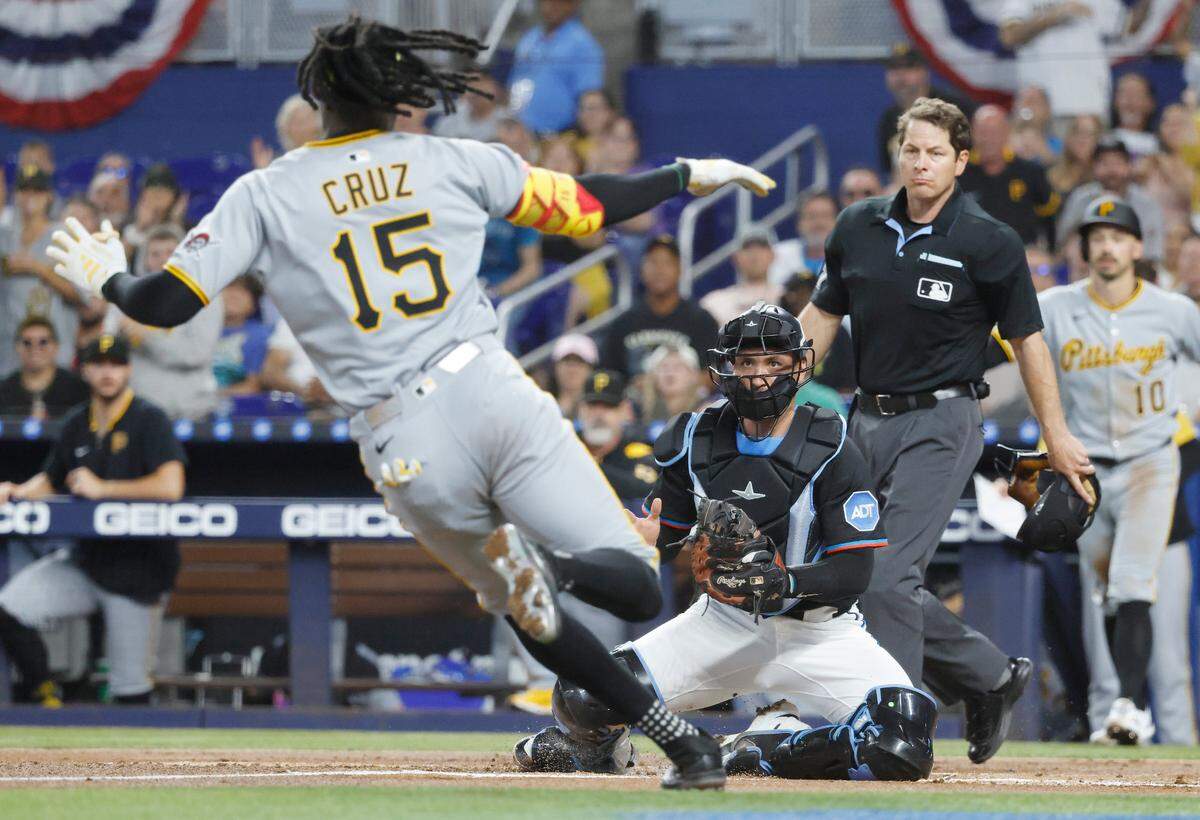 Mar 29, 2025; Miami, Florida, USA; Miami Marlins catcher Nick Fortes (4) waits for Pittsburgh Pirates outfielder Oneil Cruz (15) at the plate during the first inning at loanDepot Park. Mandatory Credit: Rhona Wise-Imagn Images