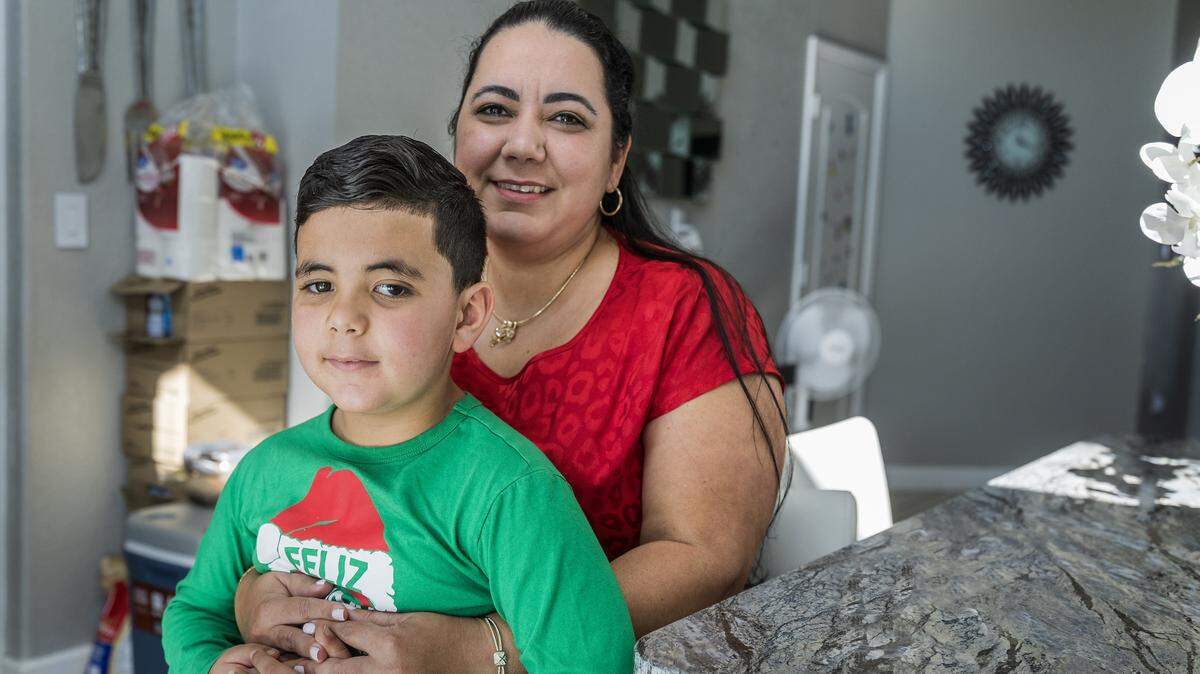 Yisel Herrera and her son Kaleb Oliva, 7 y.o, who was diagnosed with a tumor in the optic nerve, posed at home in Miami, Florida, on Wednesday, December 24, 2025.