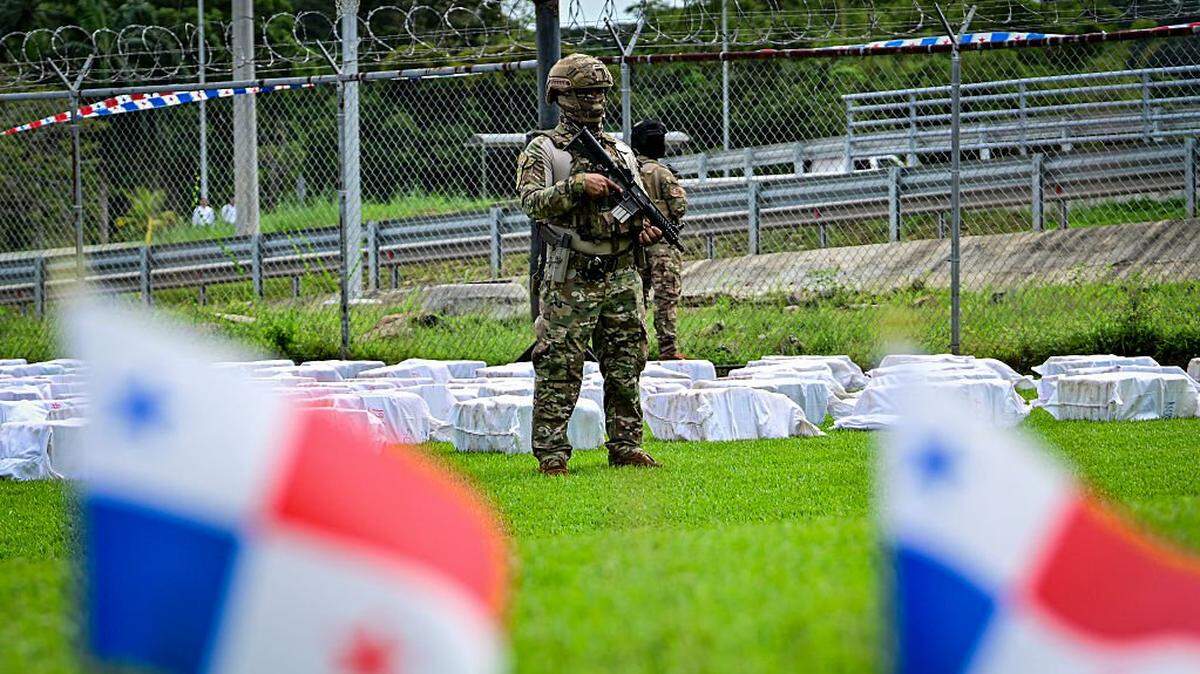 A Panamanian National Aeronaval Service officer guards 12 tons of cocaine divided into hundreds of packages at the Aeronaval headquarters in Panama City on November 11, 2025. Panama carried out one of the largest drug seizures in its history after intercepting about 12 tons of cocaine on a vessel in the Pacific that was bound for the United States, local authorities said on November 11, 2025. (Photo by Martin BERNETTI / AFP) (Photo by MARTIN BERNETTI/AFP via Getty Images)