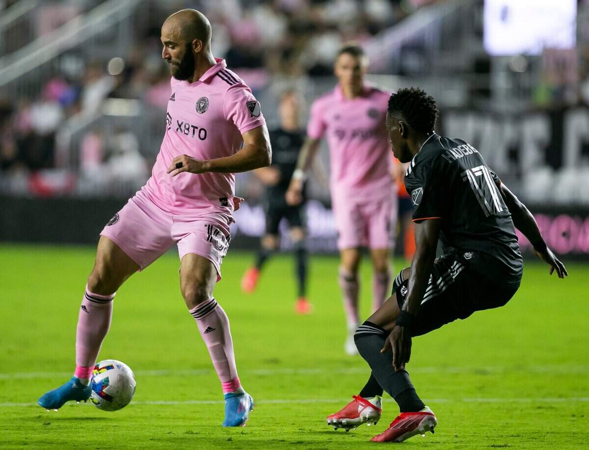 El delantero del Inter Miami Gonzalo Higuaín (izq.) pasa la pelota ante la marca de Teenage Hadebe, del Houston Dynamo, en el partido celebrado el 2 de abril de 2022 en el DRV PNK Stadium en Fort Lauderdale, Florida.