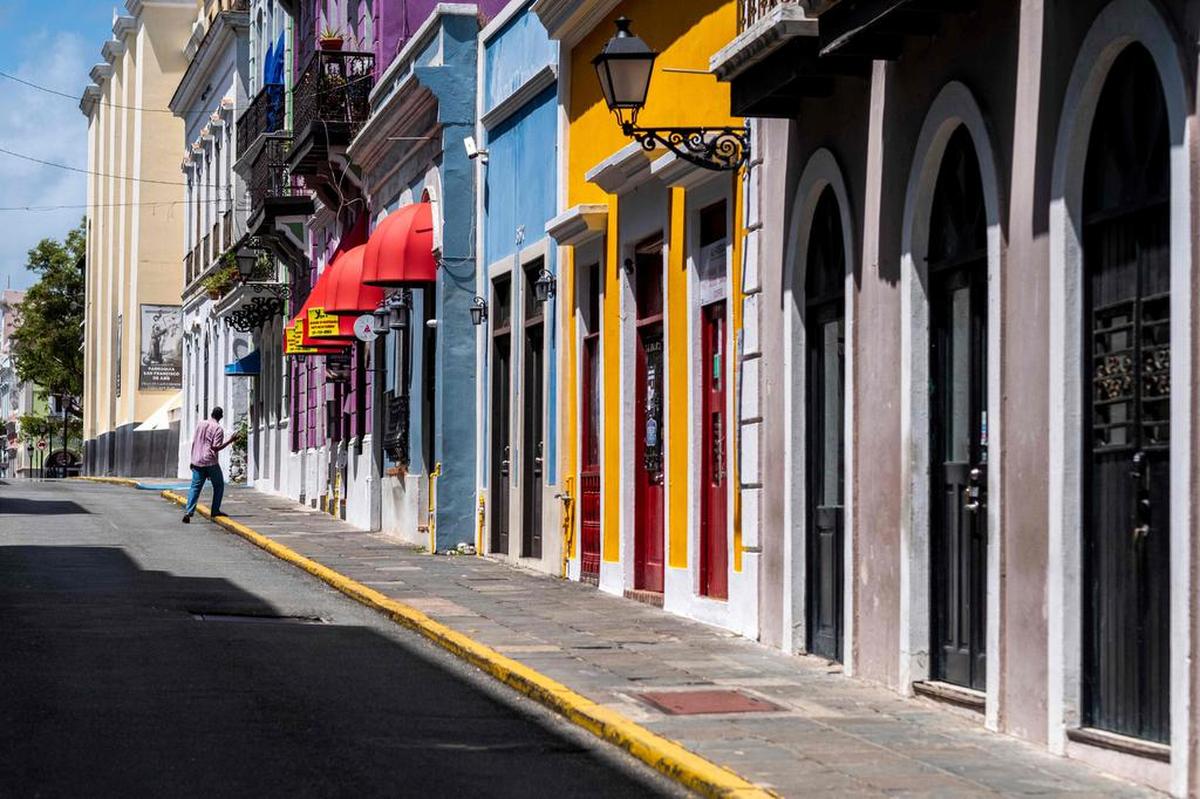 A man walks on an empty street in the tourist area of Old San Juan in San Juan, Puerto Rico.