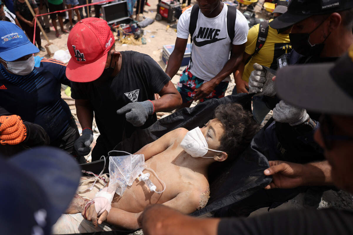 Una persona que quedó atrapada bajo los escombros de un edificio es rescatada, tras los terremotos que sacudieron el país, en La Guaira, Venezuela, el domingo 28 de junio de 2026.