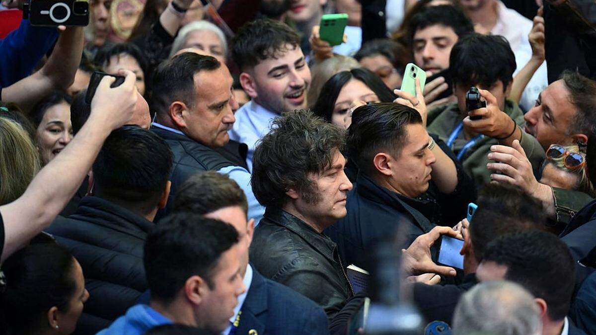 Argentina's President Javier Milei (C) leaves after voting during the national midterm legislative election in Buenos Aires on October 26, 2025. Argentines head to the polls for a midterm election that will determine whether President Javier Milei enters the second half of his term bolstered or diminished as economic troubles abound despite unprecedented US aid. (Photo by Luis ROBAYO / AFP) (Photo by LUIS ROBAYO/AFP via Getty Images)