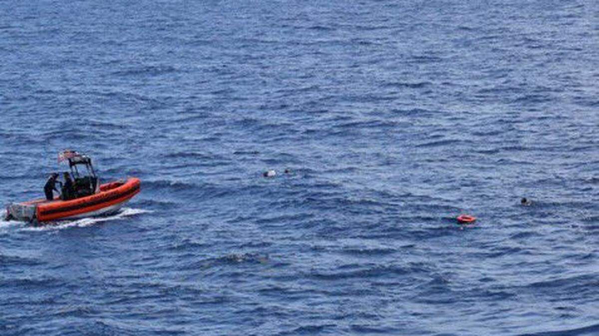 Una lancha patrullera del servico de Guarda Costa se acerca a personas en el agua a unas 16 millas al sur de Cayo Hueso el jueves 27 de mayo de 2021. Dos personas murieron cuando una embarcación volcó la noche anterior.