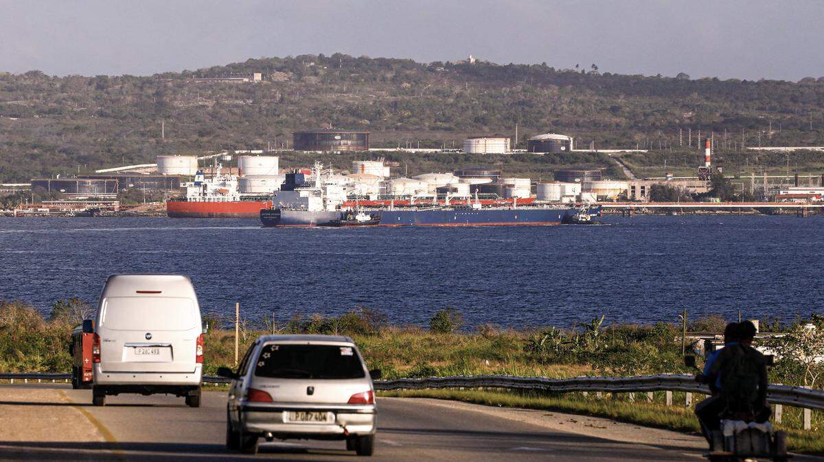 Tugboats guide the Russian oil tanker Anatoly Kolodkin as it arrives at the oil terminal in the port of Matanzas, northwestern Cuba, early on March 31, 2026. The Anatoly Kolodkin, a tanker under US sanctions carrying 730,000 barrels of crude, is set to deliver the first crude shipment to Cuba since January after Washington gave the crisis-hit island a reprieve from an effective fuel blockade. (Photo by AFP via Getty Images)