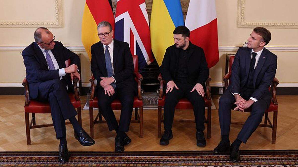 (L-R) Germany's Chancellor Friedrich Merz, Britain's Prime Minister Keir Starmer, Ukraine's President Volodymyr Zelensky and France's President Emmanuel Macron sit down ahead of a meeting inside 10 Downing Street in central London on December 8, 2025. (Photo by Adrian DENNIS / POOL / AFP via Getty Images)