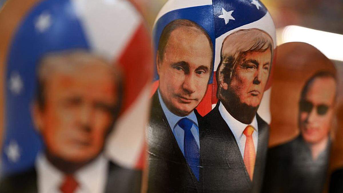 TOPSHOT - Traditional Russian wooden nesting dolls, Matryoshka dolls, depicting Russian President Vladimir Putin and US President Donald Trump are displayed for sale at a gift shop on the touristic Arbat street in downtown Moscow on October 21, 2025. Russia on October 21, 2025 said there was "no precise timeframe" for a summit between Vladimir Putin and Donald Trump on Ukraine and doused hopes for a swift preparatory meeting to finalise the talks. (Photo by Olesya KURPYAYEVA / AFP) (Photo by OLESYA KURPYAYEVA/AFP via Getty Images)