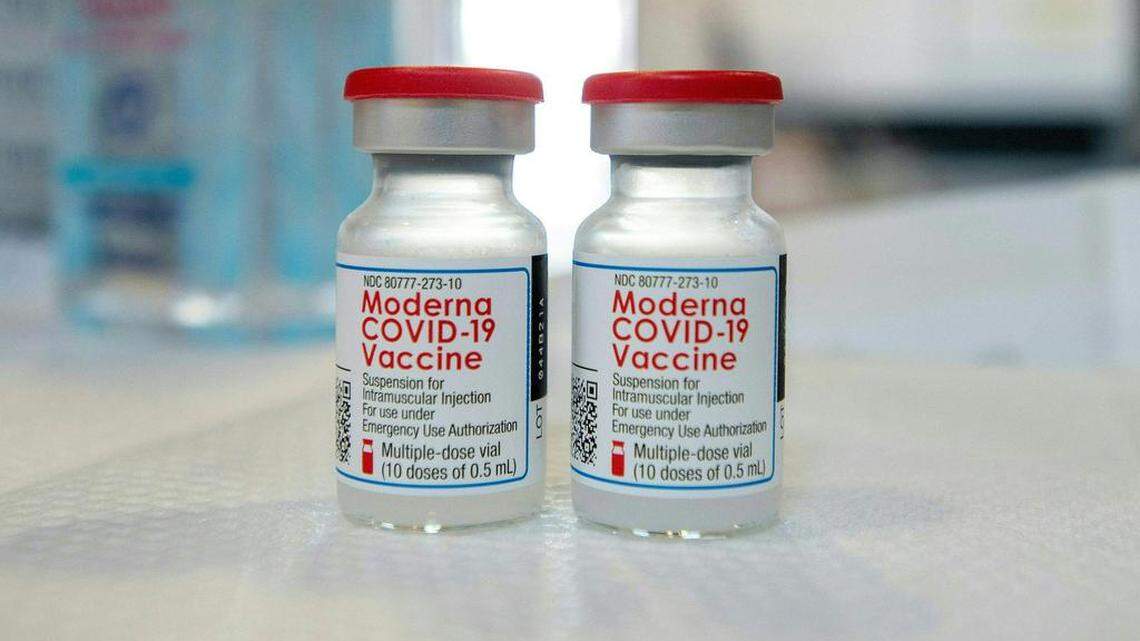 Moderna vials sit on a table before they are loaded into syringes at a mobile Covid-19 vaccination clinic, run by Hartford Healthcare at Saint Charles Borromeo Catholic Church’s McGivney community center, in Bridgeport, Connecticut on April 20, 2021.  An Axios/Ipsos poll found that 25% of unvaccinated, employed Americans said they’d be more likely to get COVID shots if they are given paid time off to do so.