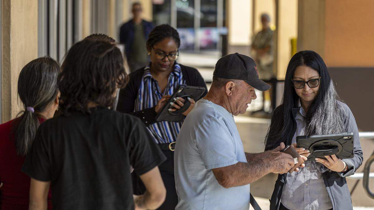 An employee at a driver’s license office in Hialeah Gardens assists residents with scheduled appointments for driver’s licenses and REAL ID services in Miami-Dade on Feb. 10.