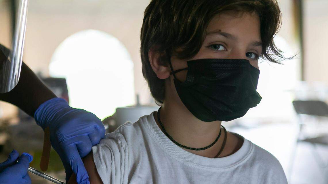 Ignacio Iglesias, 12, receives his first shot of the Pfizer COVID-19 vaccine at C.B. Smith Park in Pembroke Pines.