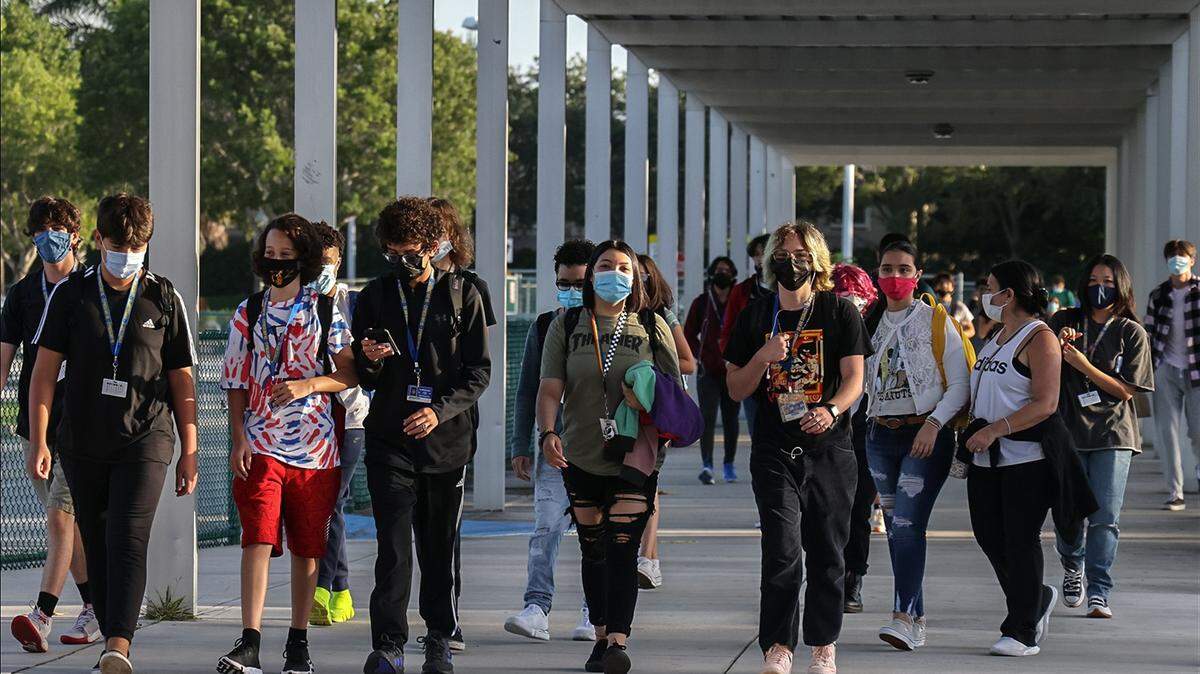 Broward Cypress Bay High School students enter campus as they returned to school under a school board mask mandate on Wednesday, Aug. 18, 2021. On Monday, Aug. 15, 2022, a Florida administrative law judge backed a decision by the Broward School Board to fire a teacher who did not comply with the district’s mask mandate last year.