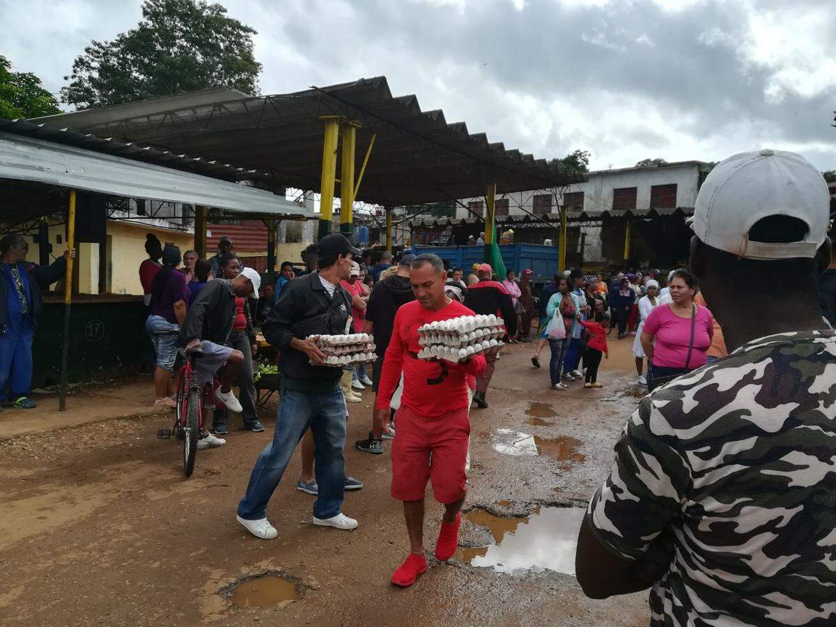 Un hombre compra huevos en la zona afectada por el tornado en La Habana.